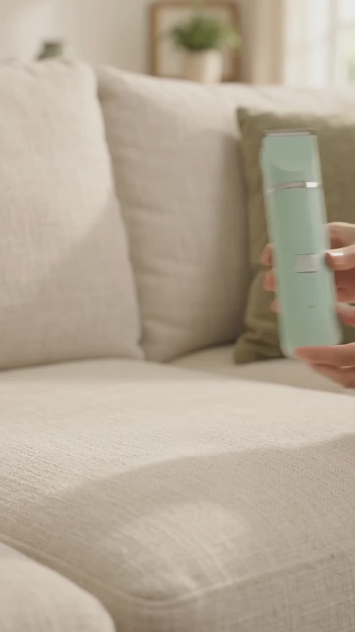 Quiet cordless grooming kit on the couch with a relaxed dog