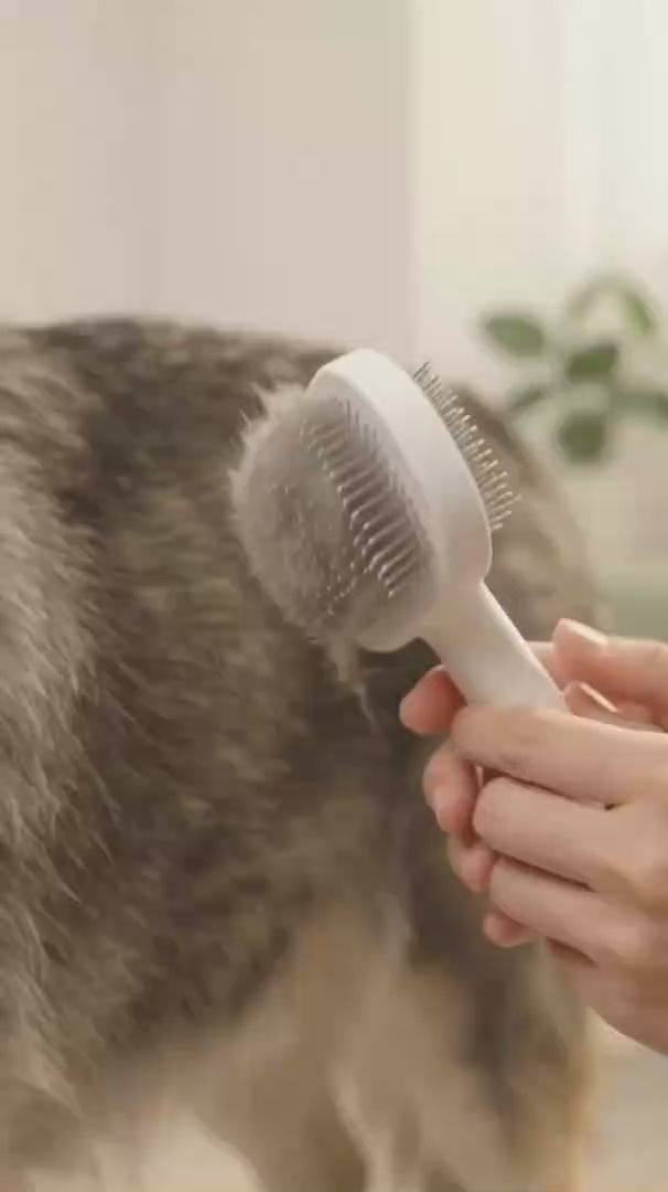Self-cleaning slicker brush full of loose fur, then releasing it with one click